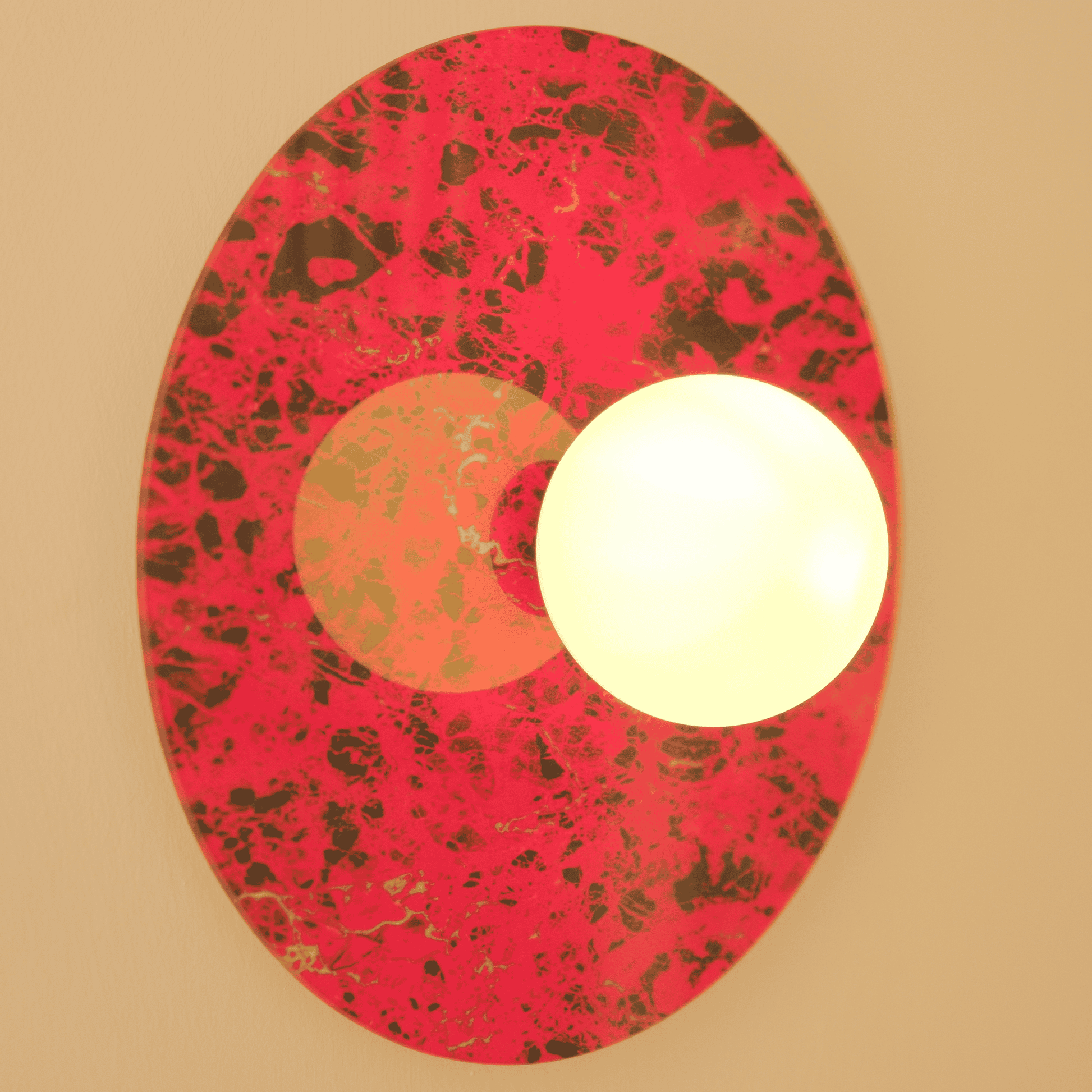 Wall-mounted red and black marbled sconce with an opaque round globe for interior lighting.