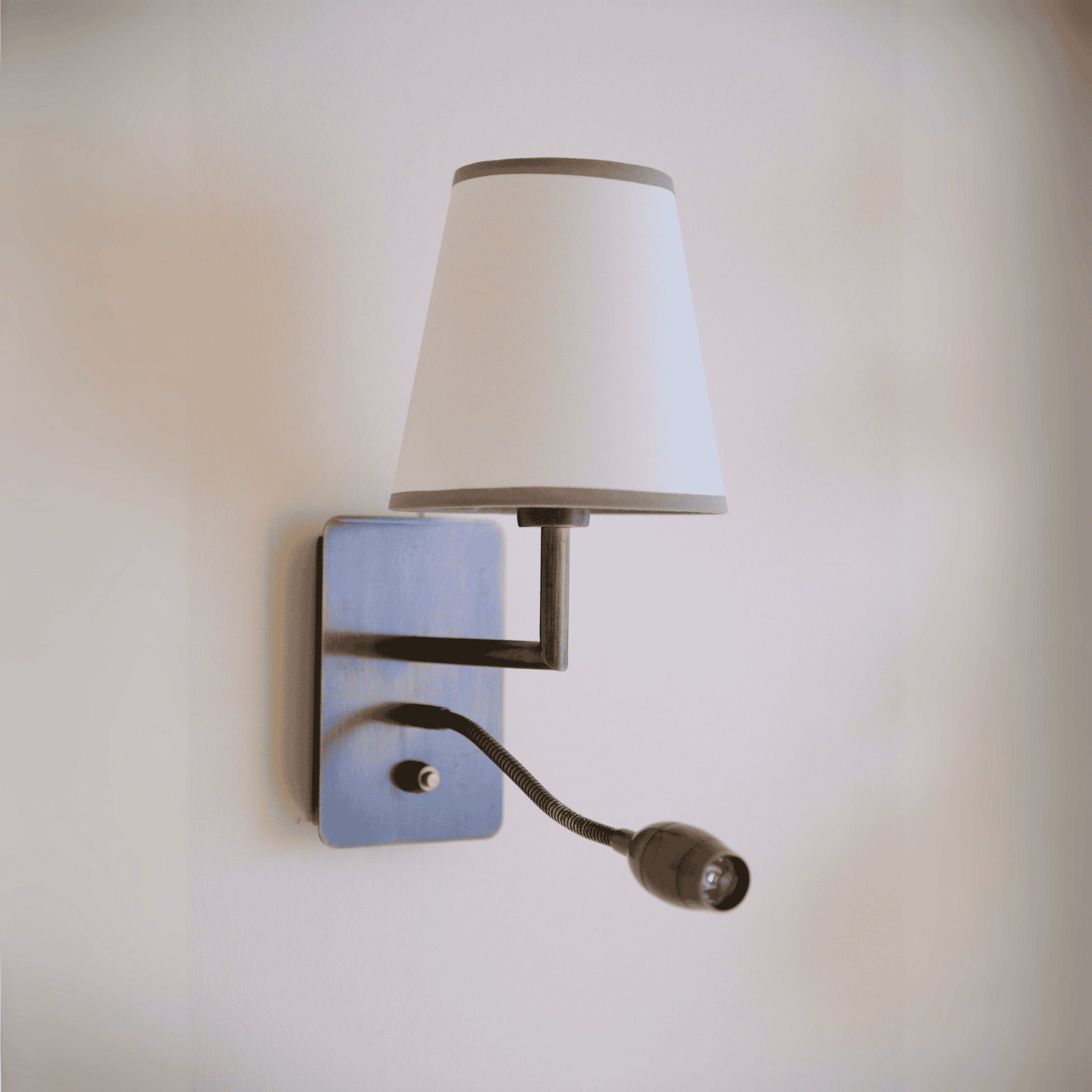 Contemporary black wall sconce with white shade and gooseneck reading light for bedroom or hallway.