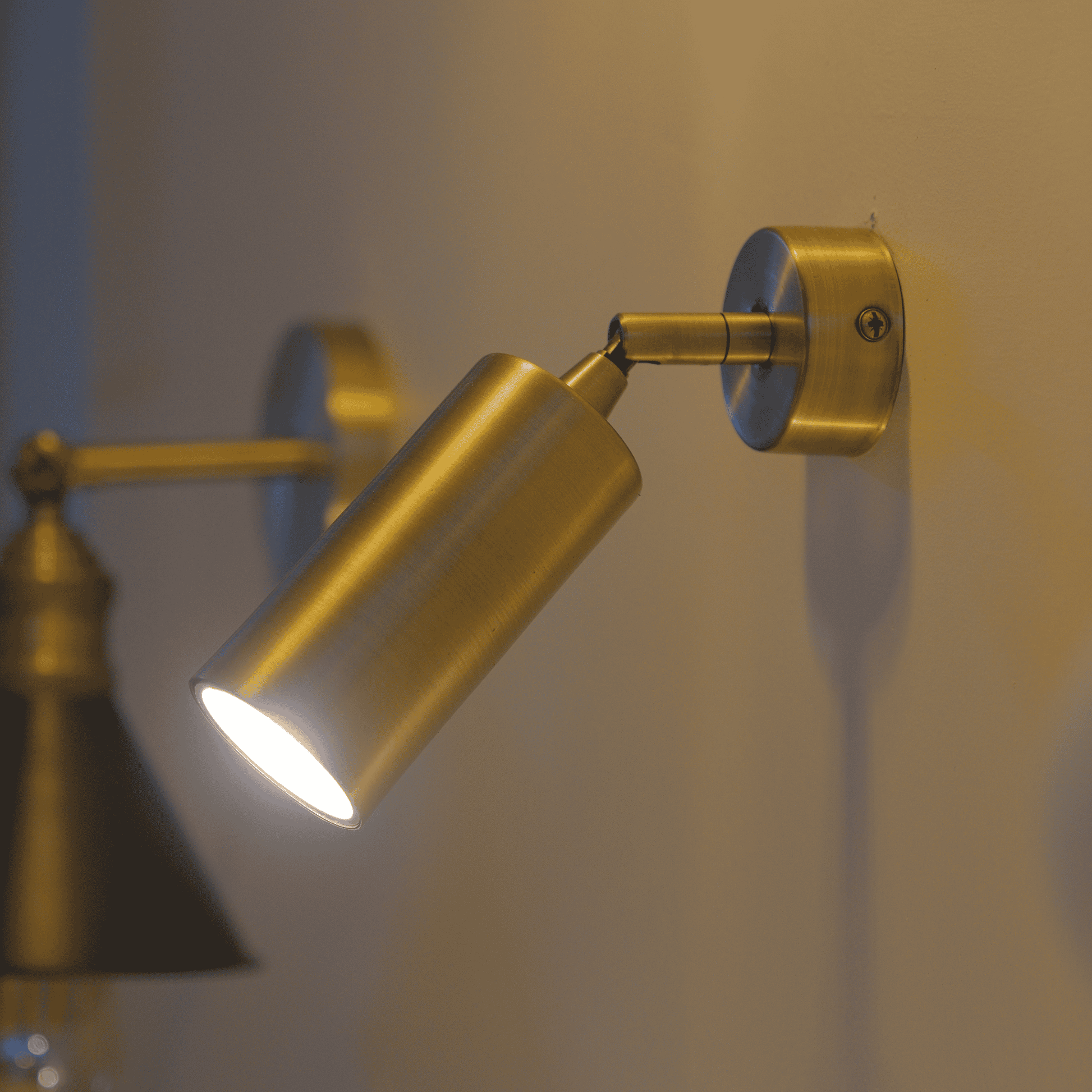 Ceiling-mounted brass cylinder spotlight for modern minimalist downlighting.