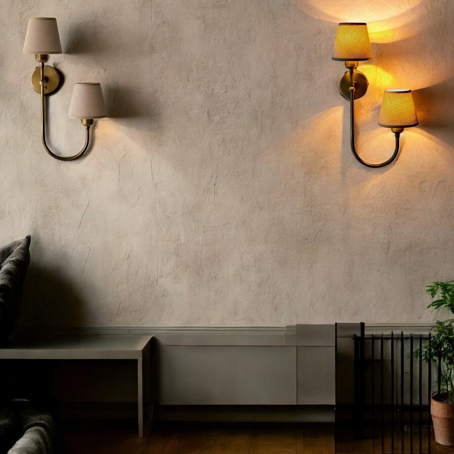 Dual fabric wall sconces with warm glow on a beige textured wall in a modern minimalist space