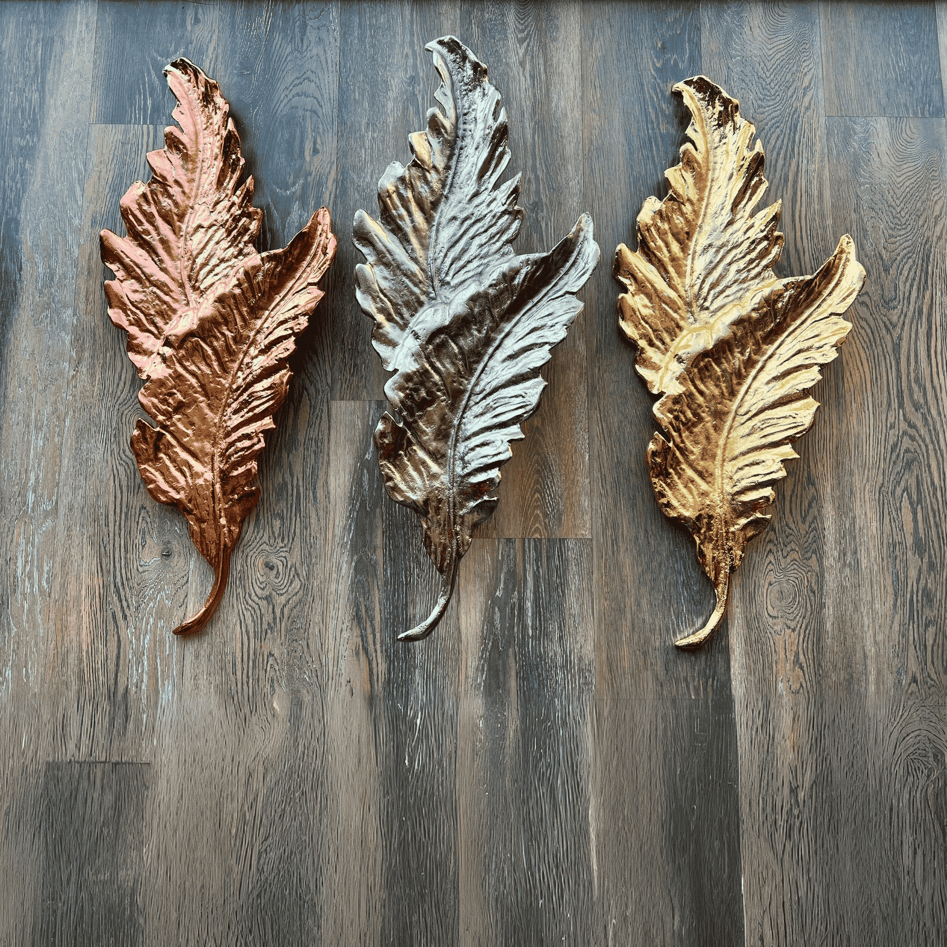 Close angled view of the Elara cast brass wall sconce showing layered leaf texture and dual light points