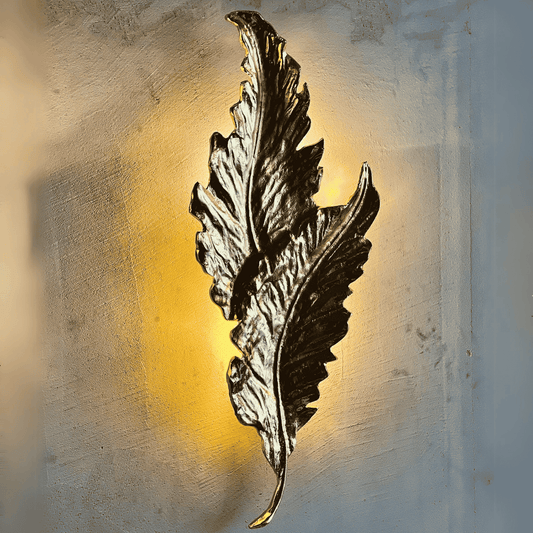 Elara wall sconce in dark aged brass finish with no visible wiring, displayed as a battery-powered cordless lighting option