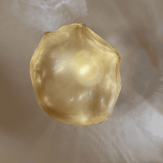 Golden natural stone-shaped glass wall sconce provides a soft ambient glow and artistic wall lighting.