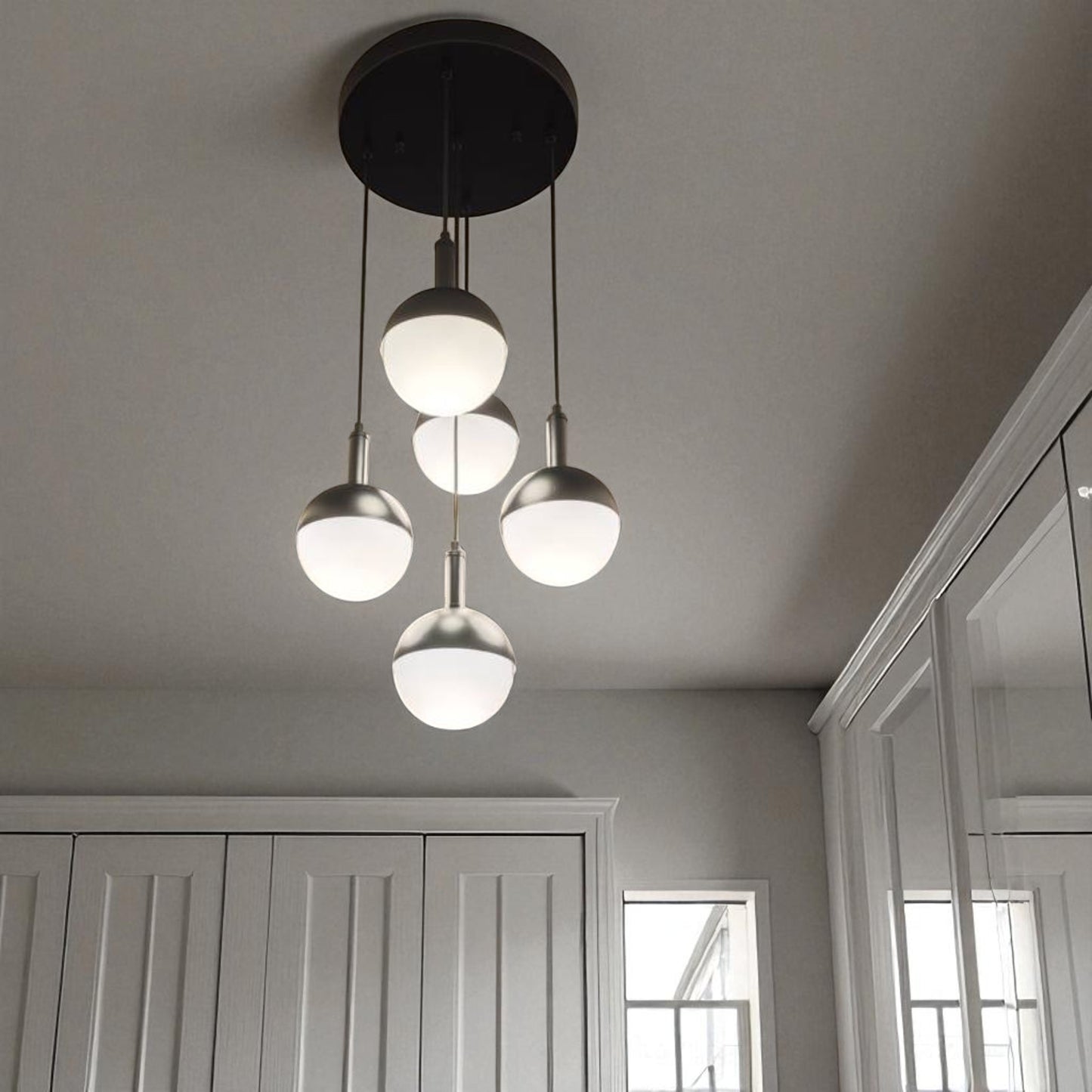 Hallway with modern globe pendant lighting and built-in wardrobe design.