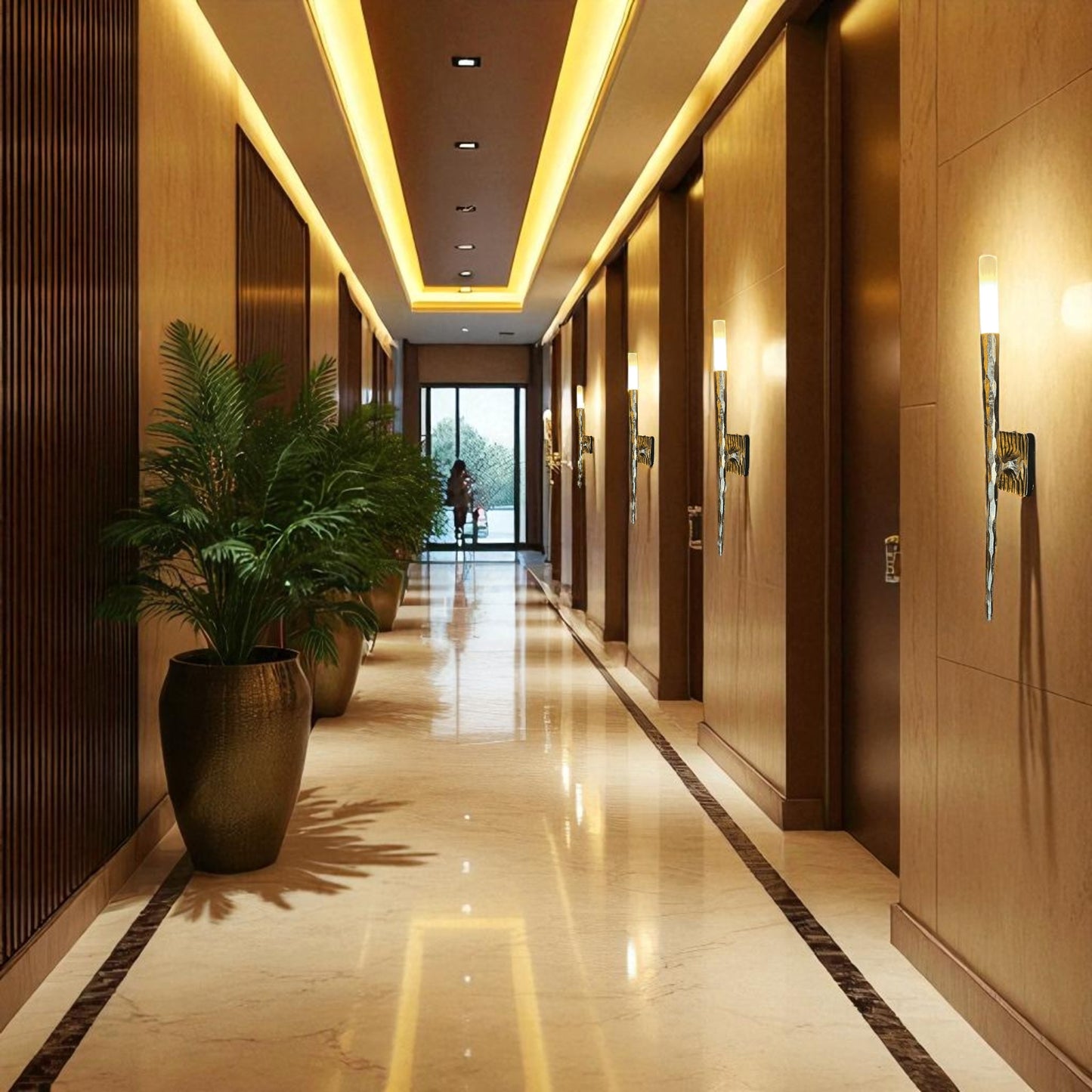 Brass wall sconces installed in a hotel corridor, creating warm, elegant lighting across a wood and marble interior.