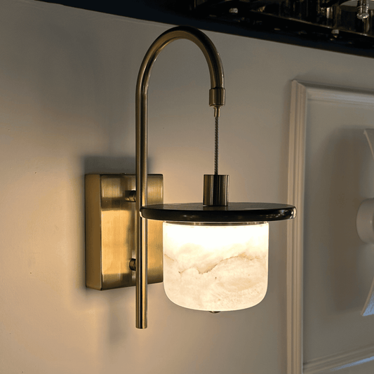 Marble sconce wall light with alabaster cylinder and brass support.