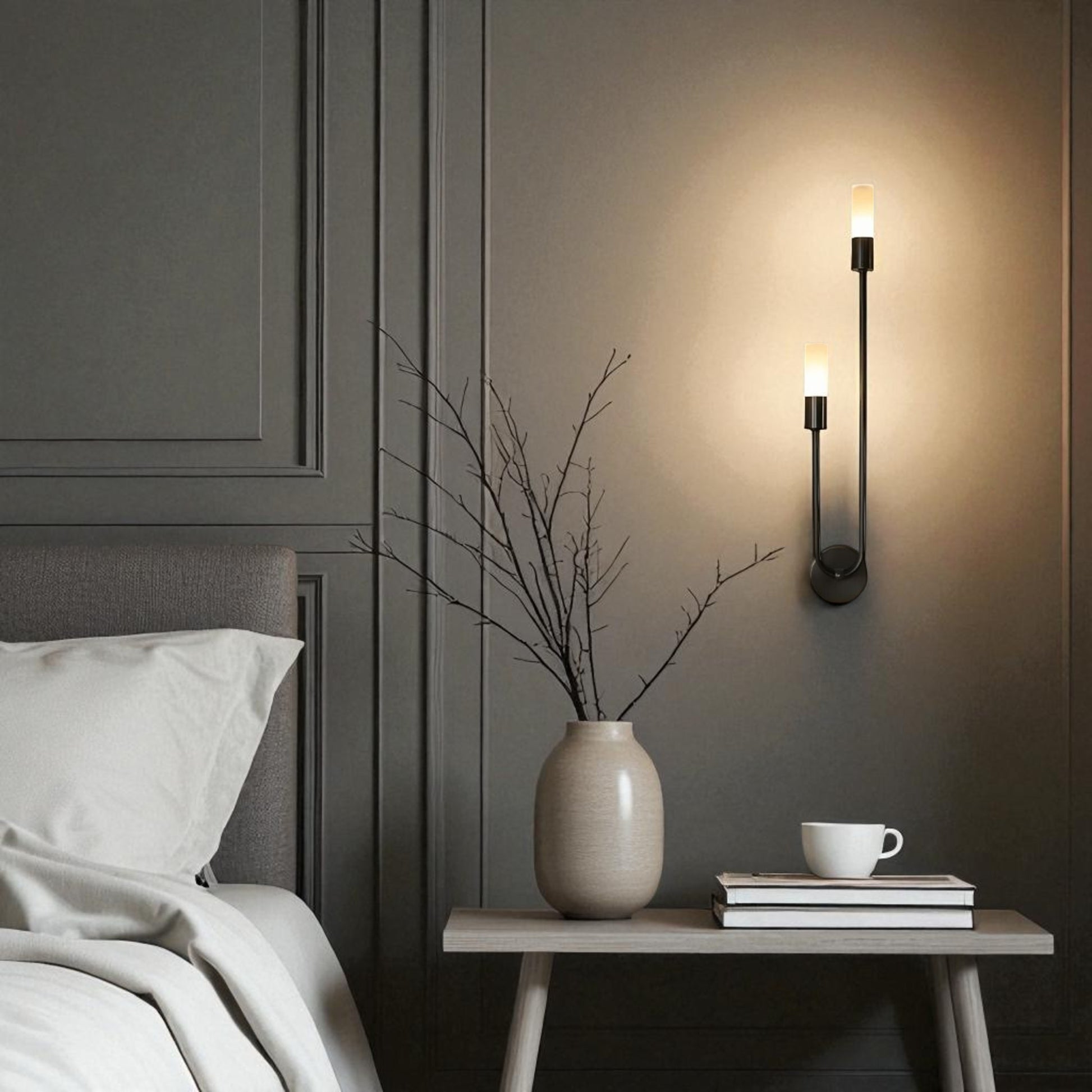 A sleek black wall sconce with dual vertical LED lights illuminates a modern bedroom wall, enhancing the minimalist decor with soft ambient lighting.