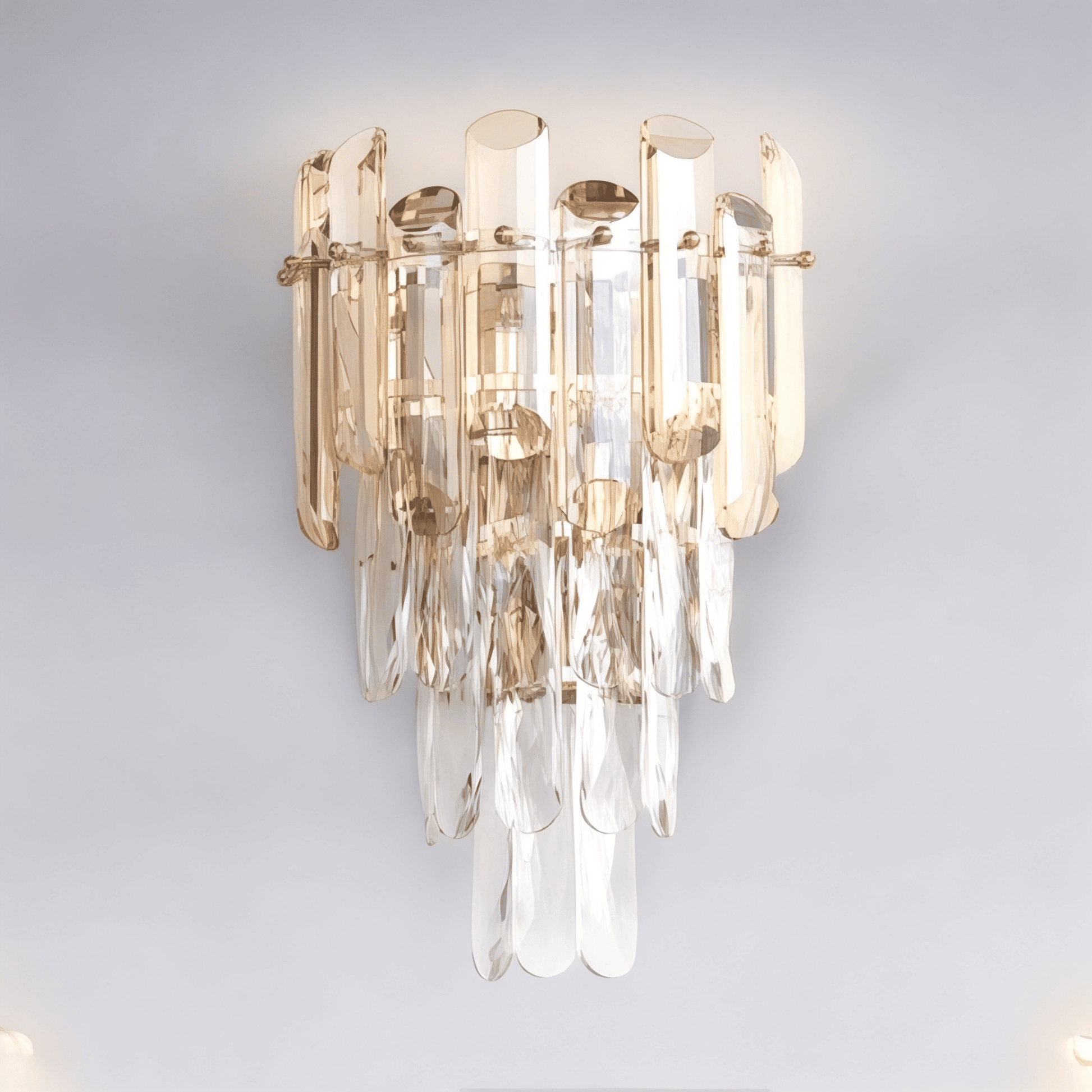 Wall sconce with clear crystal glass rods and brass metal frame mounted on a wall