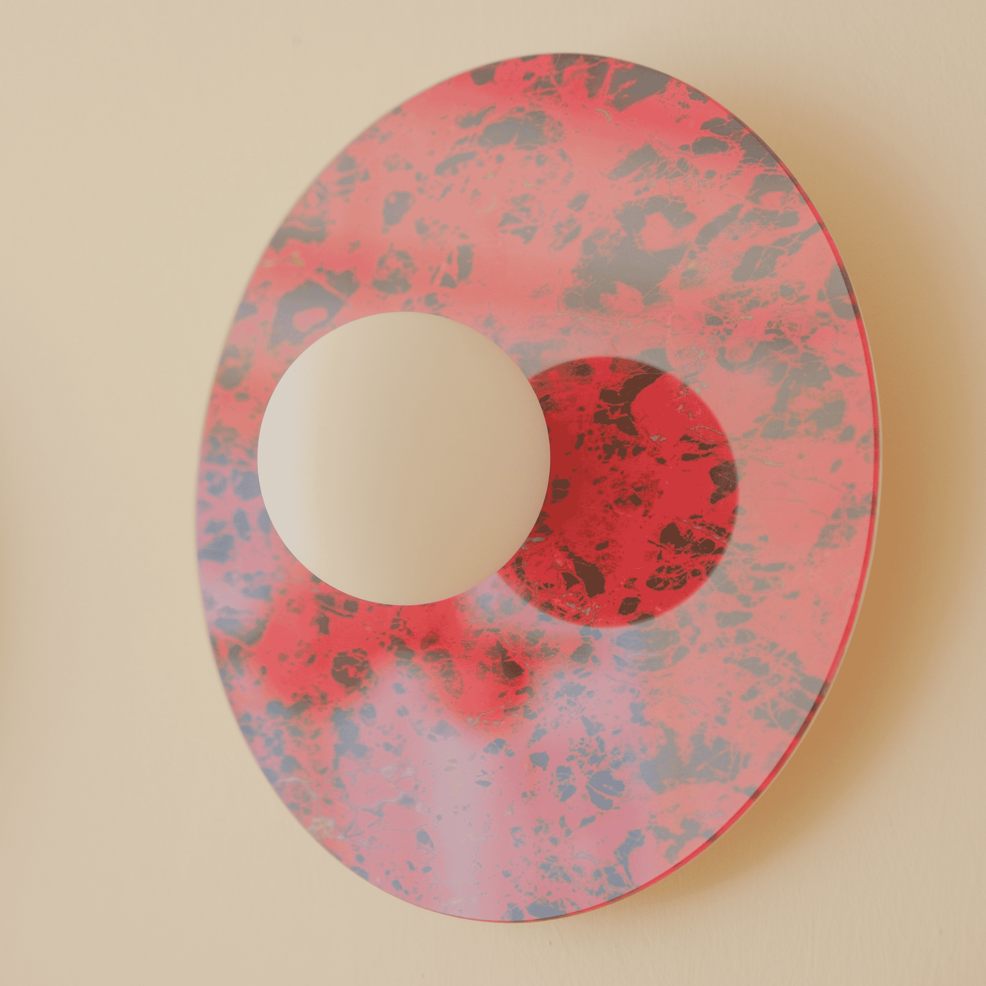 Side perspective of red marbled wall sconce with frosted globe on a beige wall.