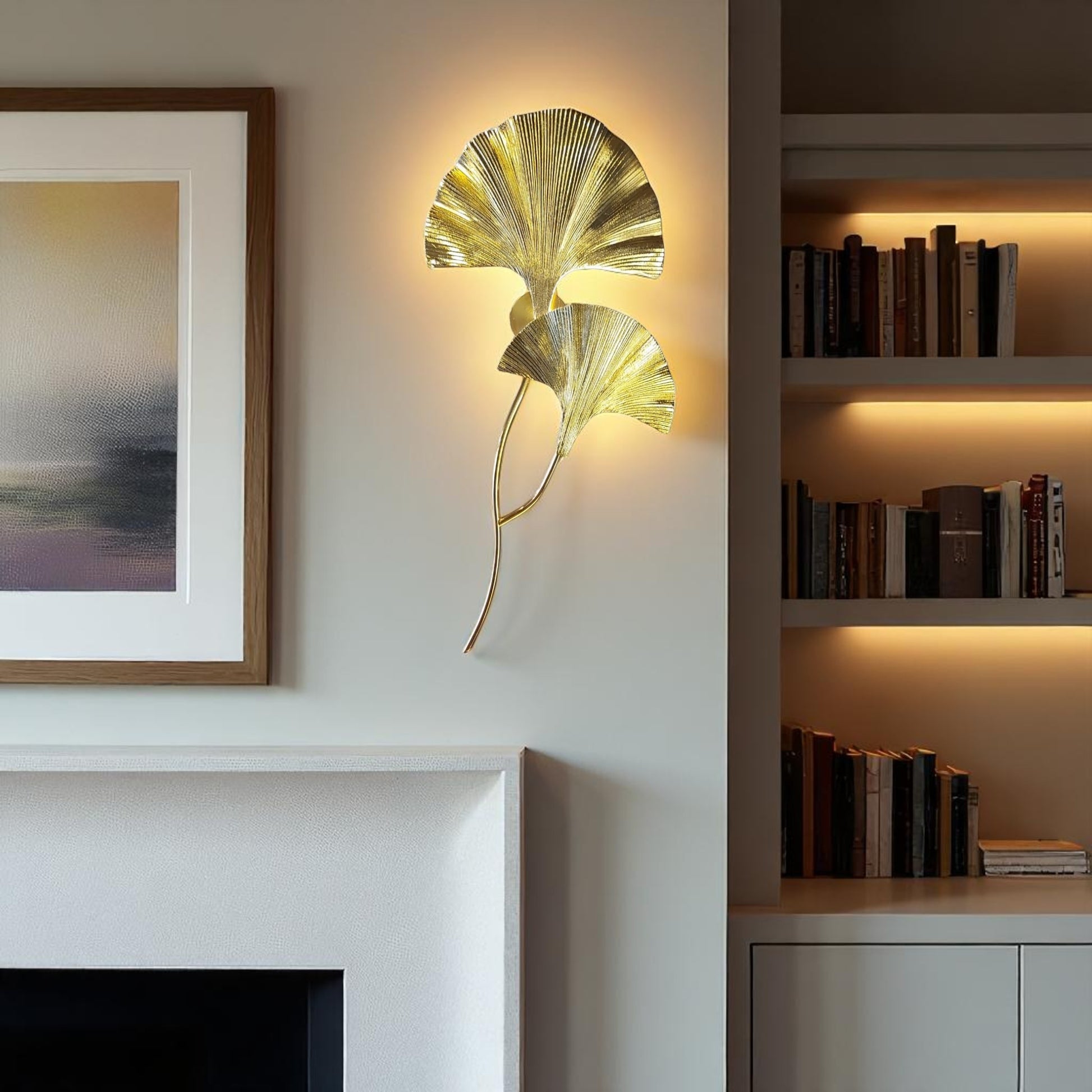 Gold sculptural wall sconce shaped like ginkgo leaves mounted beside a fireplace in a modern living room