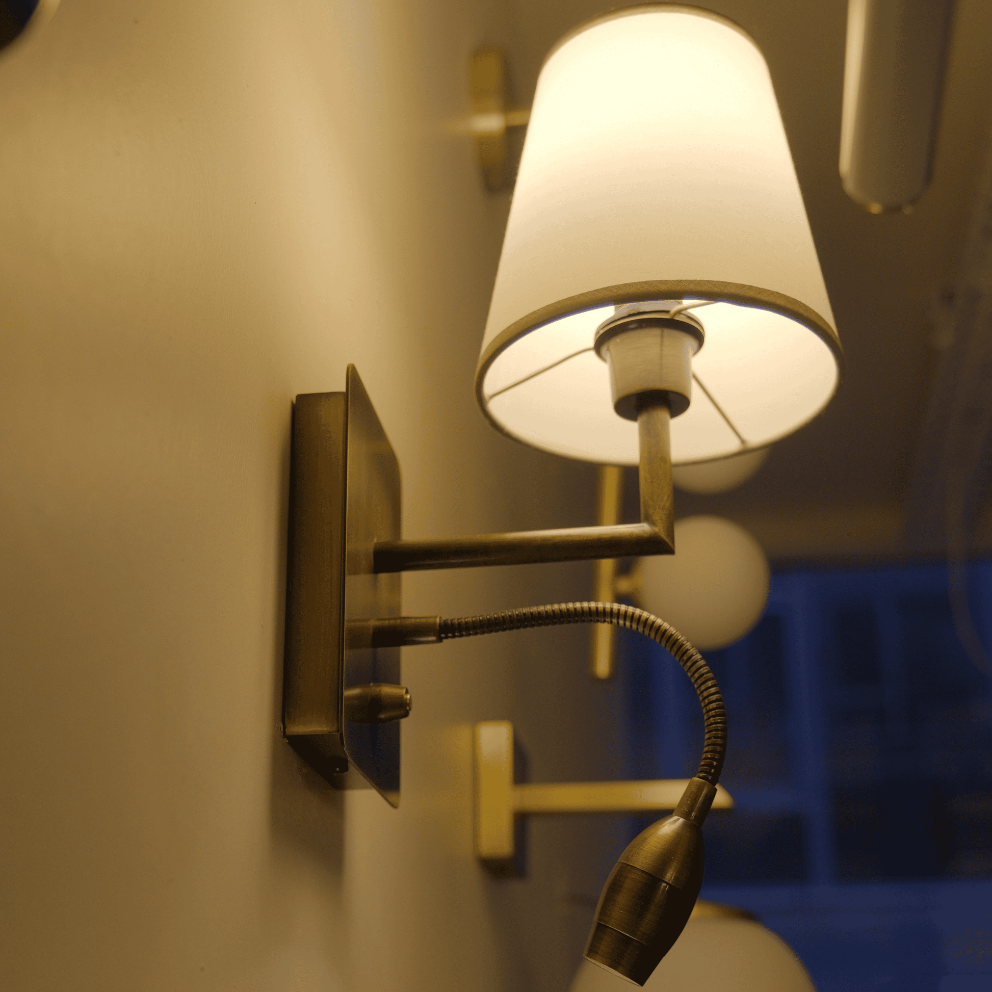 Vintage-style wall sconce with open-bottom shade and flexible LED reading arm.