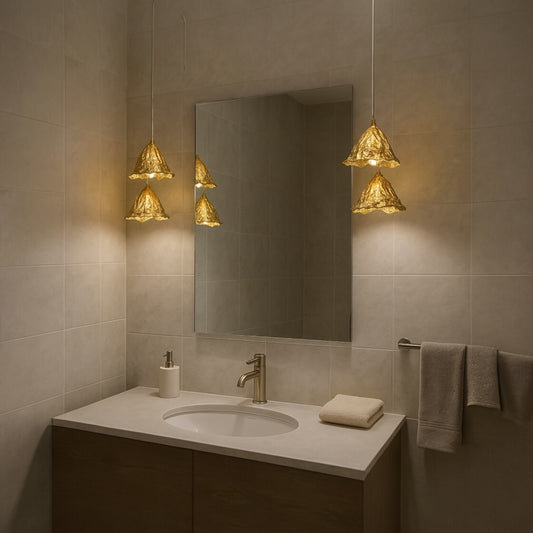 Twin pure brass leaf pendant lights framing a bathroom mirror for soft and luxurious vanity lighting.