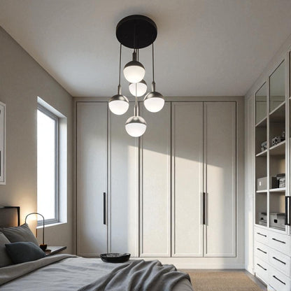 Bedroom with a modern five-globe ceiling pendant providing soft ambient light.