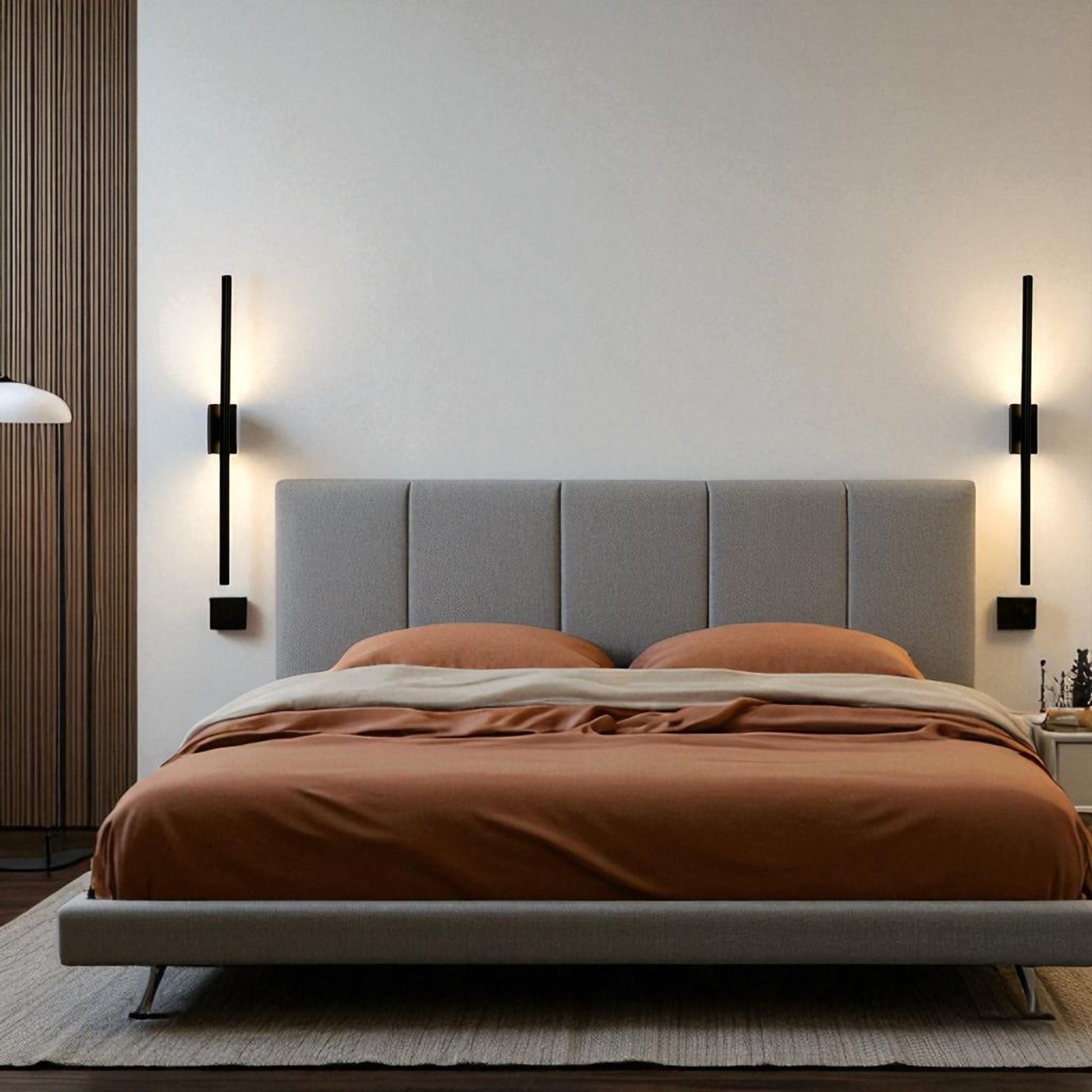 Black wall sconces provide up-and-down lighting on both sides of a gray headboard in a modern minimalist bedroom.