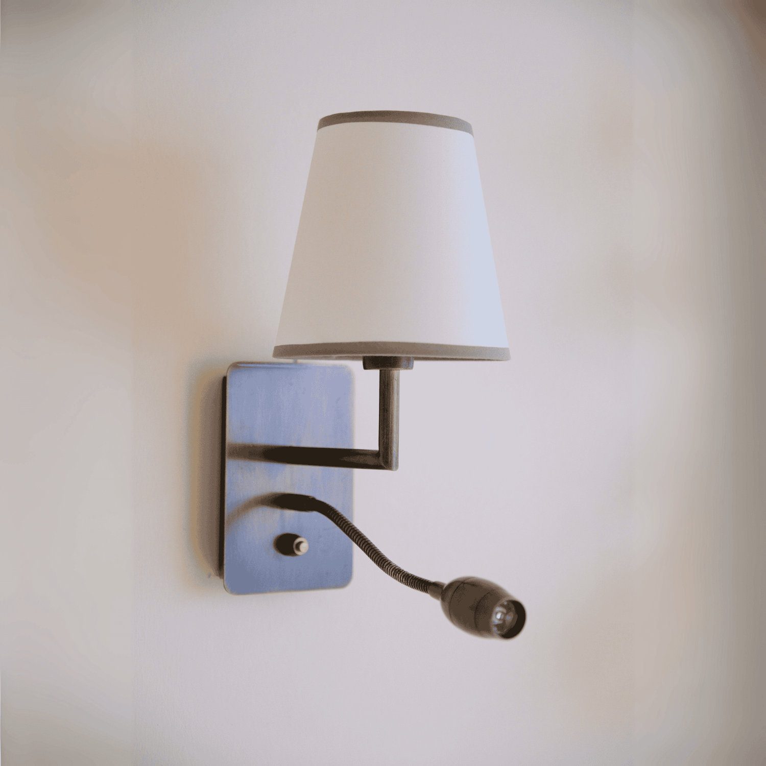 Contemporary black wall sconce with white shade and gooseneck reading light for bedroom or hallway.