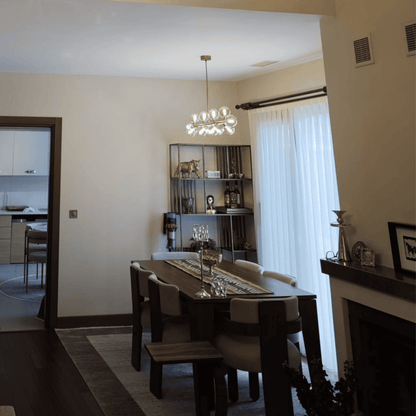 Clear Globe Glass Chandeliers Over Dining Table