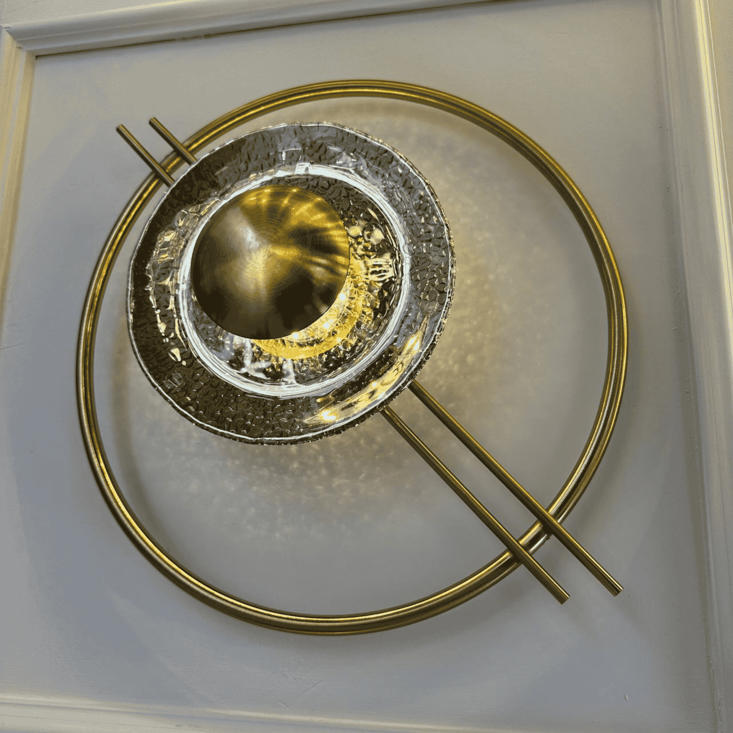 Concentric brass and glass wall light with strong Art Deco styling, ideal for stairway accent lighting.