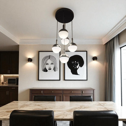 Dining area with a five-globe pendant chandelier providing balanced ambient lighting.
