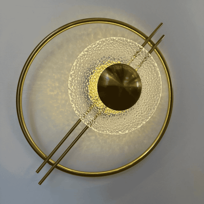 Glowing brass and textured glass wall sconce in Art Deco style, ideal for Mid-Century stairway lighting.