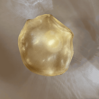 Golden natural stone-shaped glass wall sconce provides a soft ambient glow and artistic wall lighting.