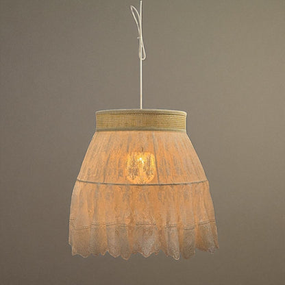 Lace pendant light above a traditional bed setting, casting soft light in a romantic bedroom interior.