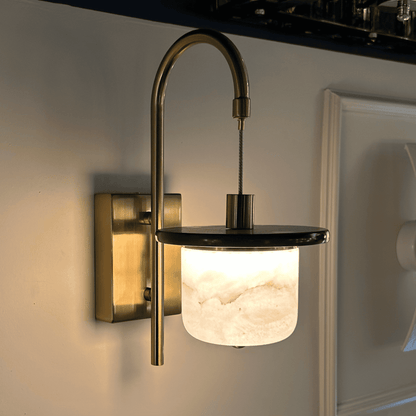 Marble sconce wall light with alabaster cylinder and brass support.