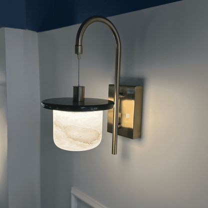 Marble sconce wall light with alabaster shade and brass detail.