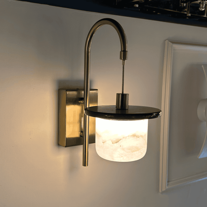 Marble sconce wall light with soft lighting and alabaster finish.