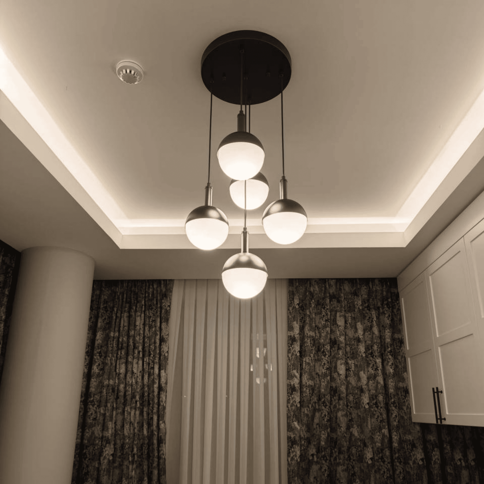Decorative room with five-globe ceiling pendant light providing ambient illumination.