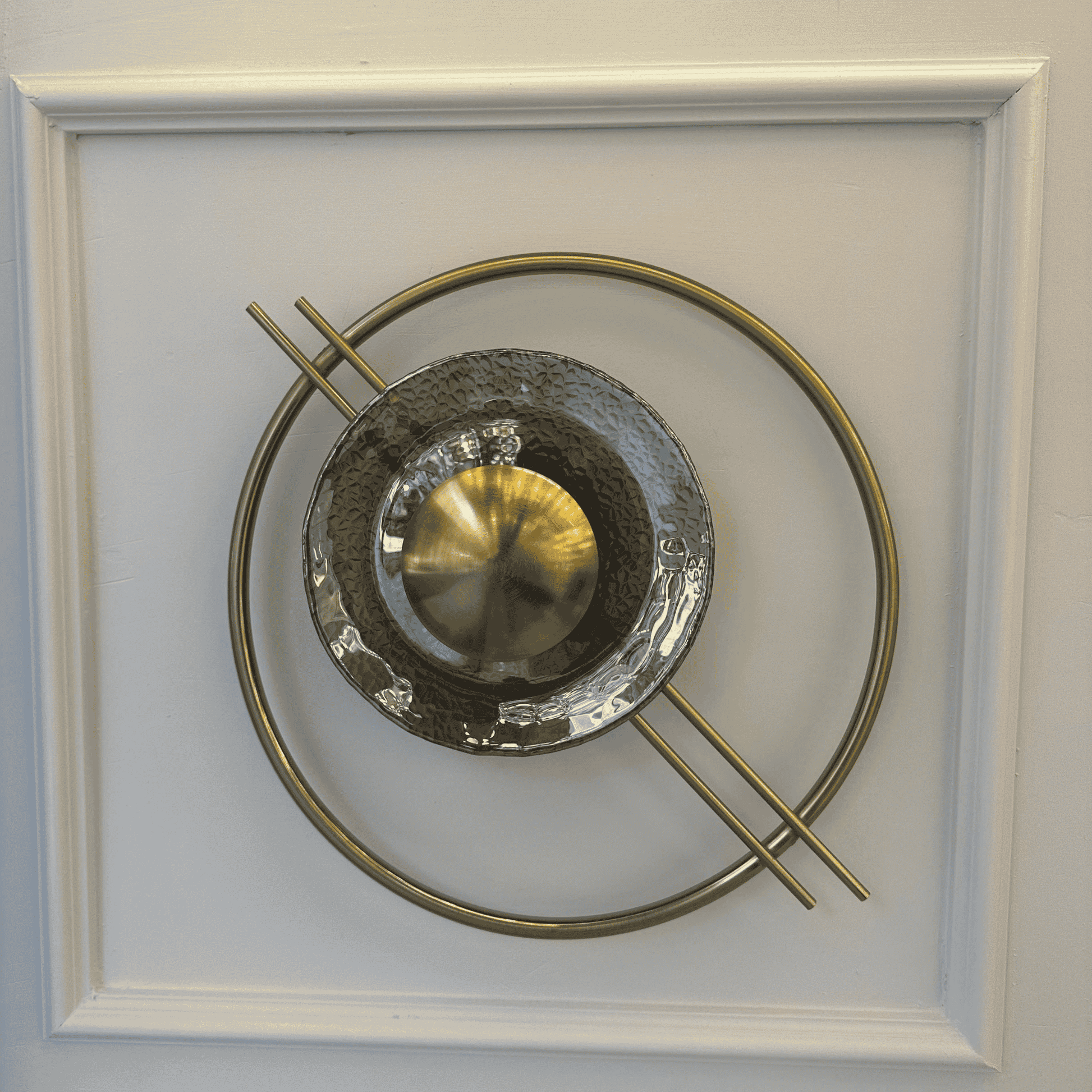 Sculptural brass and textured glass wall sconce on stairway wall, inspired by Art Deco and Mid-Century design.