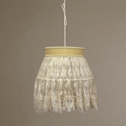 Vintage lace pendant light glowing softly in a formal room with traditional mirror and floral arrangement.
